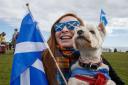 A marcher and her dog during an All Under One Banner march for independence in Arbroath