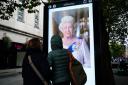 People look at a tribute to Queen Elizabeth II on Queen Street, in Cardiff. Photograph: PA