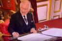 A flustered King Charles bears his teeth as he urges a servant to move a piece of stationery for him