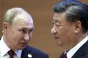 Russian President Vladimir Putin, left, speaks to Chinese President Xi Jinping (Sergei Bobylev, Sputnik, Kremlin Pool Photo via AP).