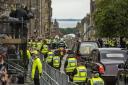 Police guard the hearse carrying the Queen's coffin along the Royal Mile, Edinburgh