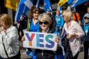 A woman holding a Yes Scotland placard at a Scottish independence march in Inverness this year (Paul Campbell)