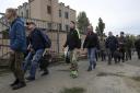 Russian recruits walk past a military recruitment centre in Volgograd, Russia