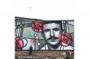 Rogue One (aka Bobby McNamara) with his Mackintosh mural on the banks of the Clyde