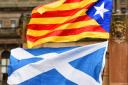 A Catalan flag and Saltire fly side-by-side