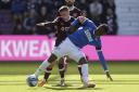 Hearts midfielder Cammy Devlin attempts to win the ball off Rangers winger Rabbi Matondo at Tynecastle today