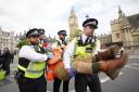 Police made 27 arrests after protesters glued themselves to the road in Parliament Square