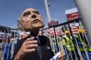 A protestor wears a Sepp Blatter mask
