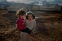 Syrian refugee children play in the Za’atari refugee camp on January 31, 2013