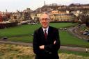 Donald Dewar standing in front of the site where the new Scottish Parliment will be built..
