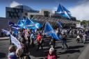 Independence supporters march past Holyrood (Credit: Stewart Attwood)