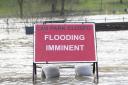 A flood warning sign at the entrance to a flooded car park in Whitesands, Dumfries in December 2022