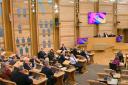 MSPs turn around to see what the shouting is about during FMQs
