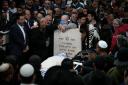 Mourners at the funeral of an Israeli couple killed in a gun attack outside a synagogue in Jerusalem