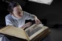 Keira McKee, a book conservator at the University of Glasgow, works on the University of Glasgow’s First Folio copy