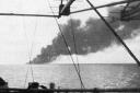 The plume of smoke from the stricken HMS Dasher, taken from one of the nearby ships, HMS Isle of Sark, on March 27, 1943