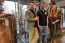 Co-owners Jon (left) and Victoria Erasmus (right) with Master Distiller/Brewer Bruce Smith (centre) at the opening of Uile-bheist Distillery, the first distillery to open in Inverness for 130 years