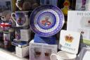 King Charles III coronation merchandise on display in a shop window near to Windsor Castle