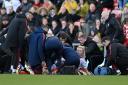 Arsenal's Leah Williamson is treated by medical staff during a game against Manchester United. It turned out to be an ACL injury