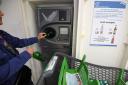A customer deposits empty returnable glass bottles into a device at a hypermarket in Mundolsheim, eastern France