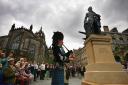A crowd watch the unveiling of a statue of Scottish philosopher Adam Smith at the Royal Mile in Edinburgh