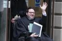 Nicholas Rossi raises his hand as he leaves Edinburgh Sheriff and Justice of the Peace Court