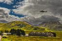Two helicopters (one in flight and one landed to the left) were used to stop in 'for breakfast' at a Glencoe hotel