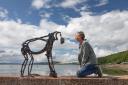 Helen with one of her orangutan sculptures made from old motorbike frames