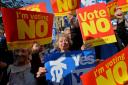 People hold Yes and Vote No signs in 2014 for some reason