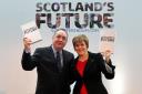 Alex Salmond and Nicola Sturgeon pictured holding copies of the Scotland's Future white paper for independence