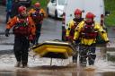 Members of a rescue team make their way through flood waters in Brechin