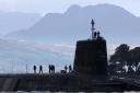 A Trident submarine makes its way out from Faslane Naval base in Faslane