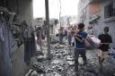 Palestinians carry a body after the Israeli bombardment in the Maghazi refugee camp in the Gaza Strip