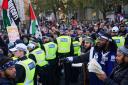 A police line separates members of the Black Hebrew Israelite Movement (right) and Pro-Palestinian protesters