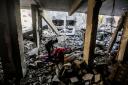 People search through buildings, destroyed during Israeli air raids in the southern Gaza Strip