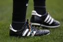 An official wearing boot laces supporting Stonewall's Rainbow Laces campaign