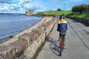A child cycling to Blackness Castle