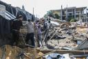 People inspect the damage to their homes following Israeli air strikes in Rafah