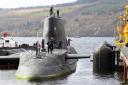 A submarine is shown docking at Faslane in a handout photo from the Ministry of Defence