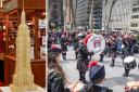 A band plays at a parade in New York to mark Tartan Week, and Walker's Shortbread's Empire State Building model