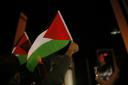 A pro-Palestine protester waves a flag in support of the war-torn nation