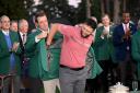 Jon Rahm slips into the green jacket after winning the 2023 Masters