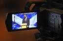Humza Yousaf speaking at the SNP conference, seen through a camera