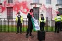 Police officers at the Ministry of Defence in London, after members of Youth Demand threw red paint over the outside of the building