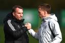 Celtic manager Brendan Rodgers, left, shakes hands with Alistair Johnston during training at Lennoxtown