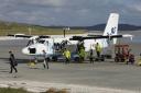 Staff unload passengers from a flight at Barra Airport