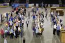 Huge sports and entertainment arena transformed into a food packing factory to help feed starving children
