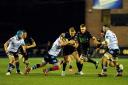Kyle Steyn of Glasgow Warriors is tackled by Kristian Dacey of Cardiff Blues