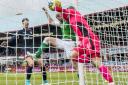 Dundee goalkeeper Scott Bain keeps the ball out the net as Hibernian’s David Gray challenges