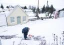 A man clears the snow in Leadhills, South Lanarkshire as Storm Barra hits the UK and Ireland with disruptive winds, heavy rain and snow
